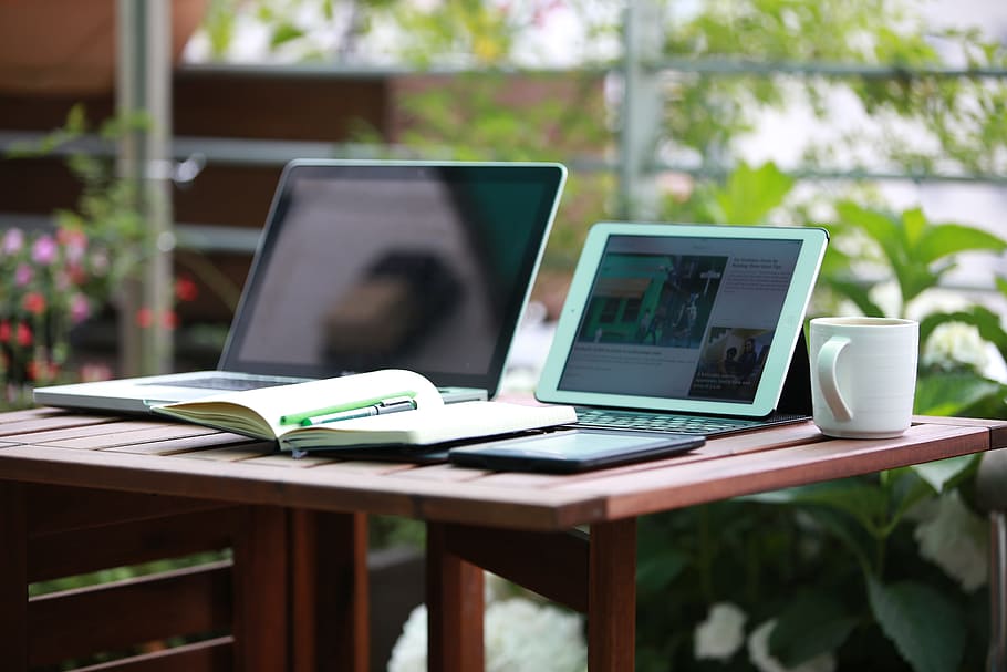 white tablet computer and computer keyboard on table near mug HD wallpaper