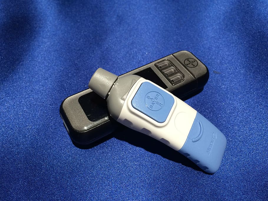two blue, white, and gray Bayer wireless devices on blue textile HD wallpaper