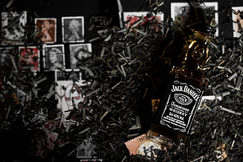 Jack Daniels bottle, Jack Daniel's whisky bottle on postage stamps and metal tools HD wallpaper