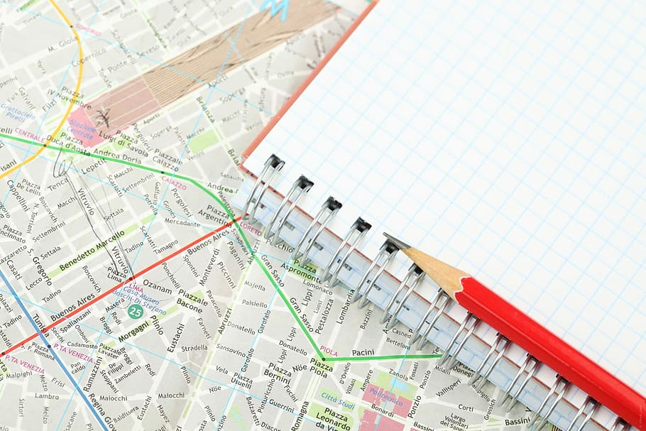 red pencil on open spring notebook on map, instruction, direction HD wallpaper