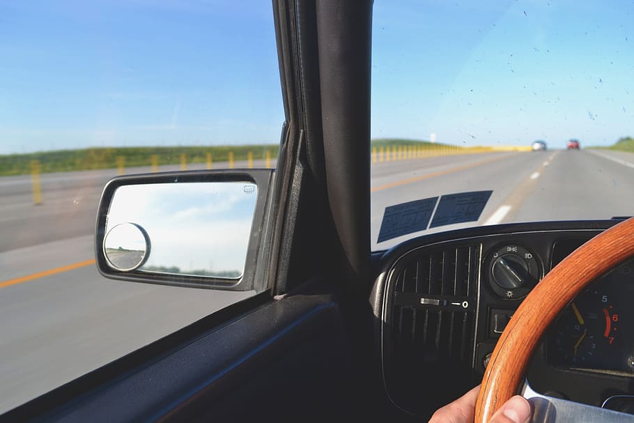 person riding inside vehicle passes on asphalt road, car, steering wheel HD wallpaper