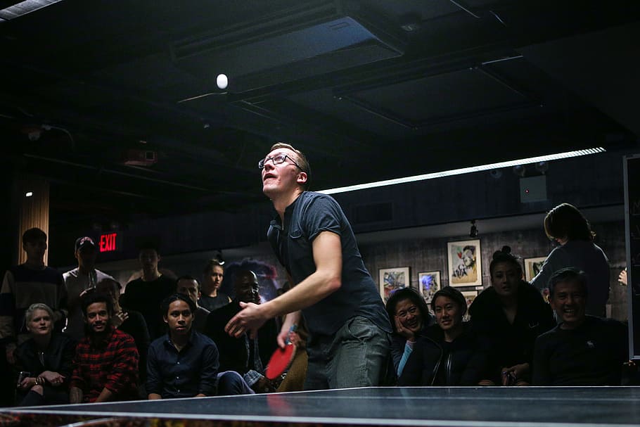 man about to paddle ping pong ball surrounded by group of people, people watching man playing table tennis HD wallpaper