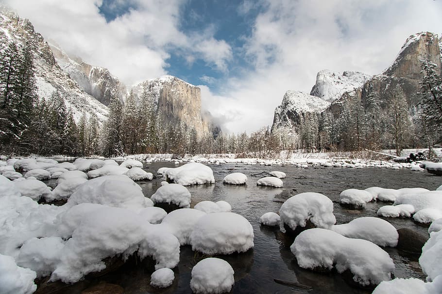 scenery of stones on body of water, water with ice near the brown mountain under the white cloud during daytime HD wallpaper