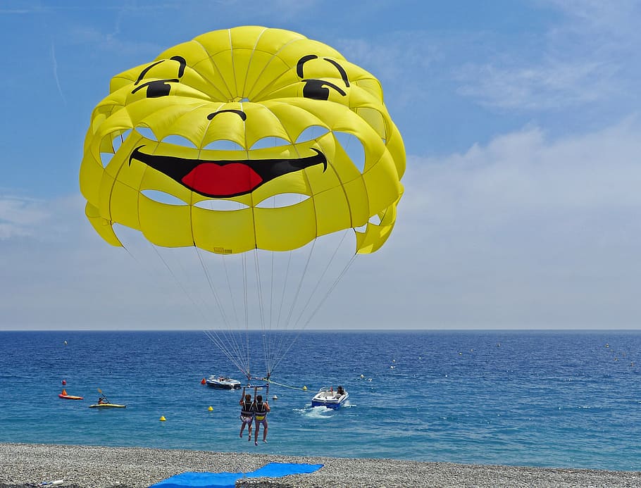 two person ride on parachute over body of water, parasailing HD wallpaper