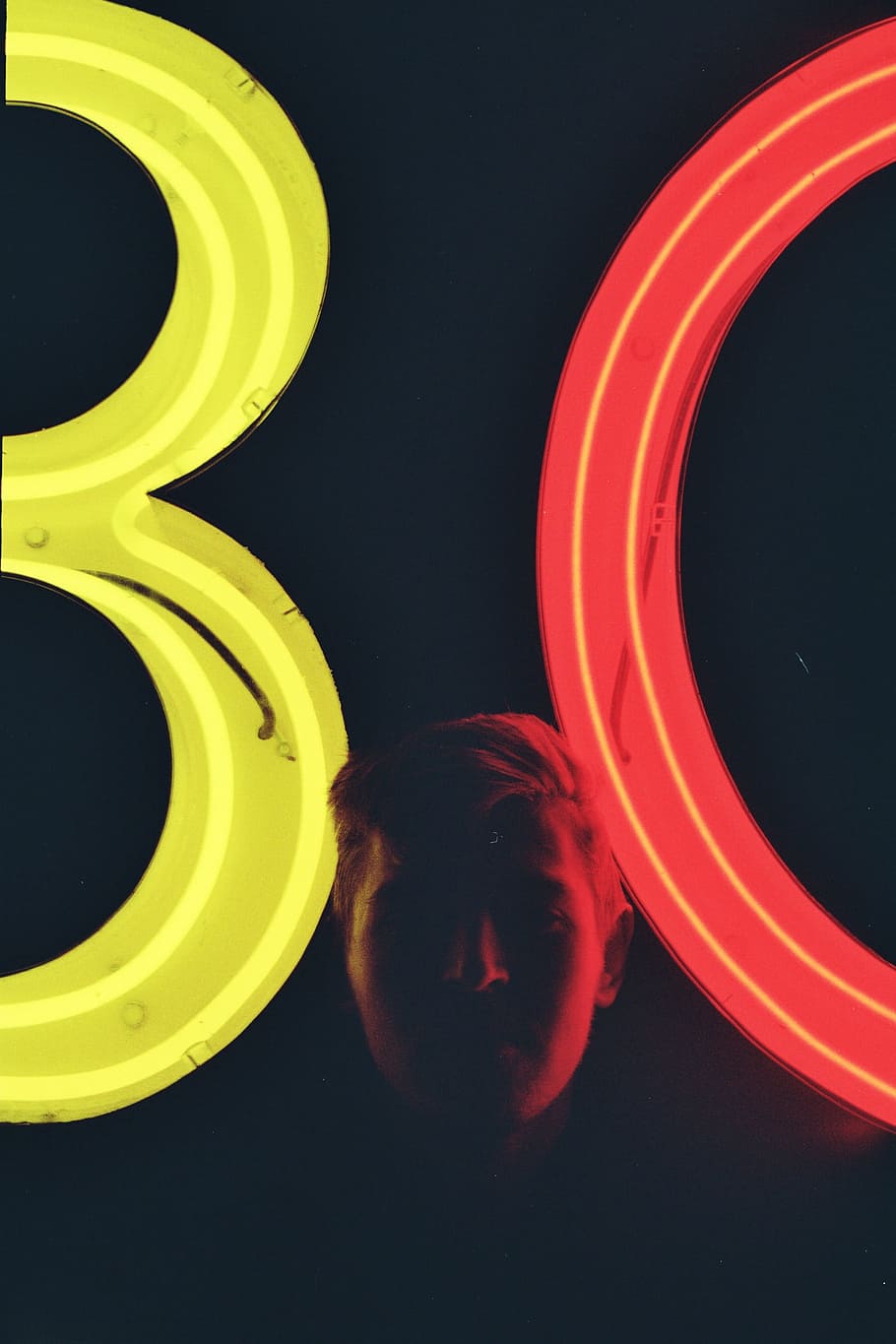 man neat lighted signages, person standing near yellow and red 80 neon standee HD wallpaper