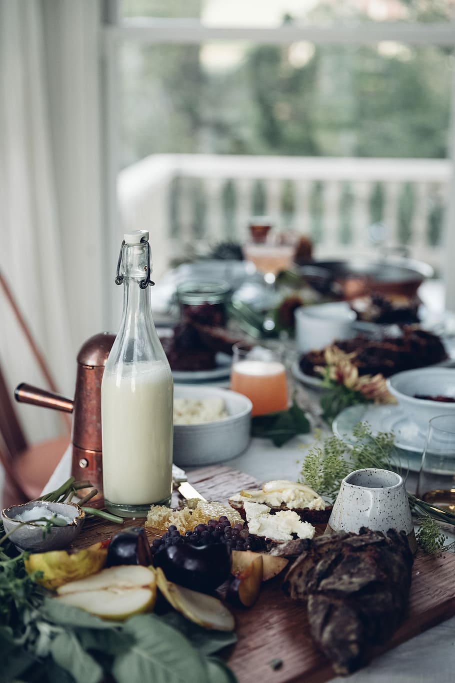 shallow focus photo of white liquid filled glass bottle, half filled milk glass bottle on table HD wallpaper