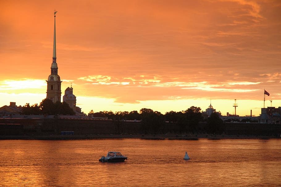 white boat floating on sea at sunset, st petersburg russia, the peter and paul fortress