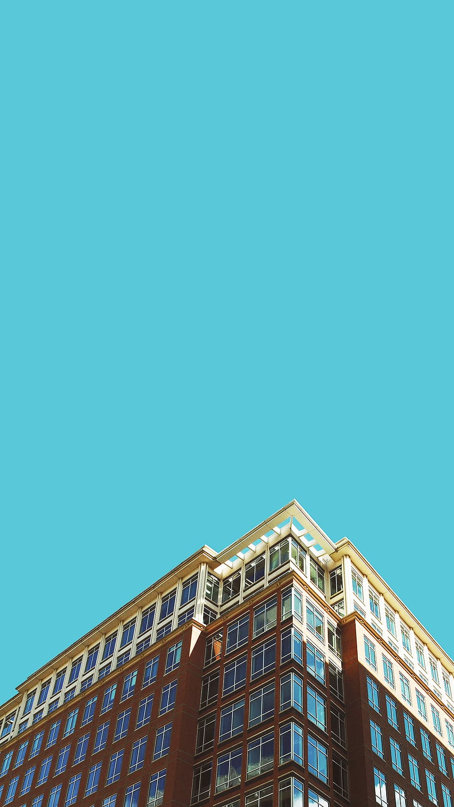 Reach, low angle photography brown high rise building under blue sky HD wallpaper