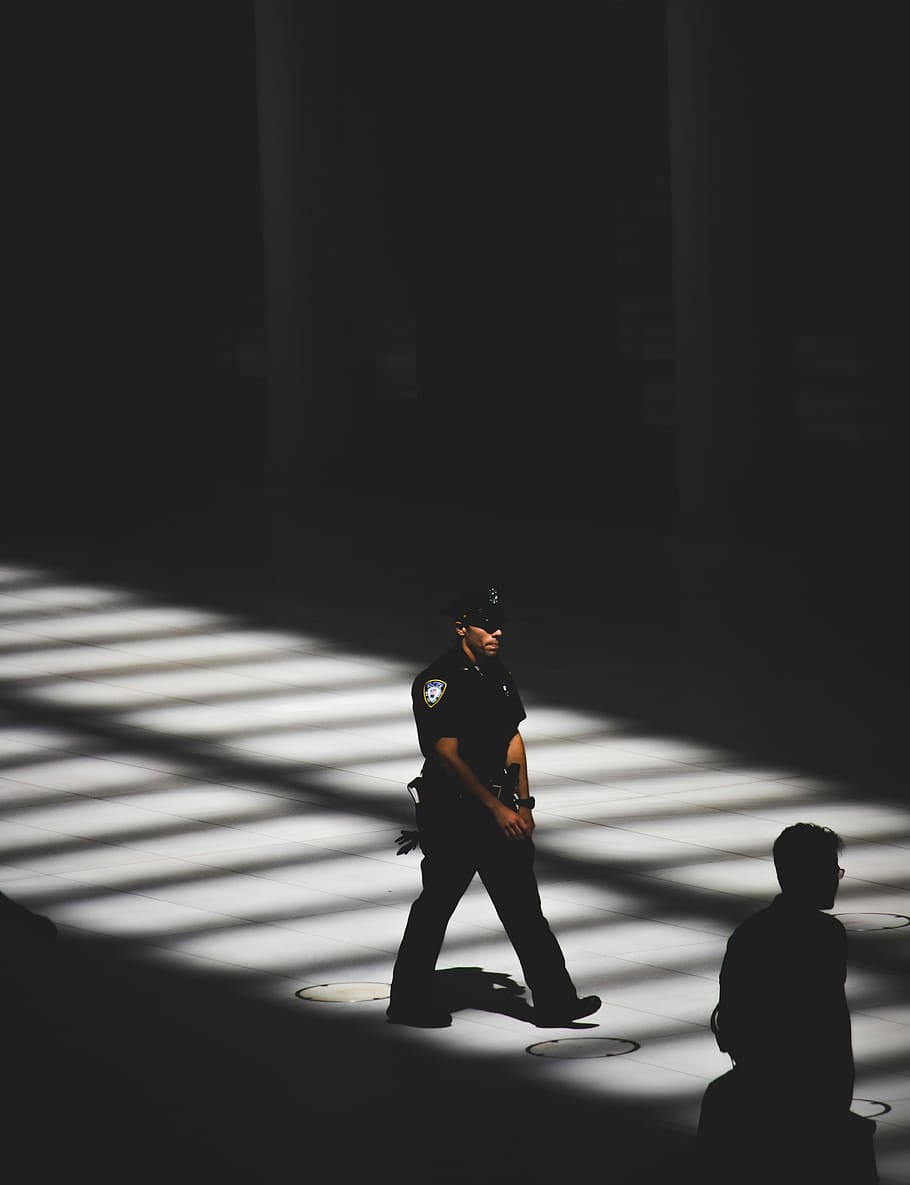 man in black police uniform, police man walking on road, sunlight HD wallpaper