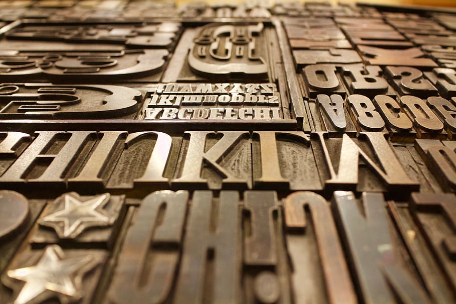 letters embossed brown wooden panel, printing plate, font, type