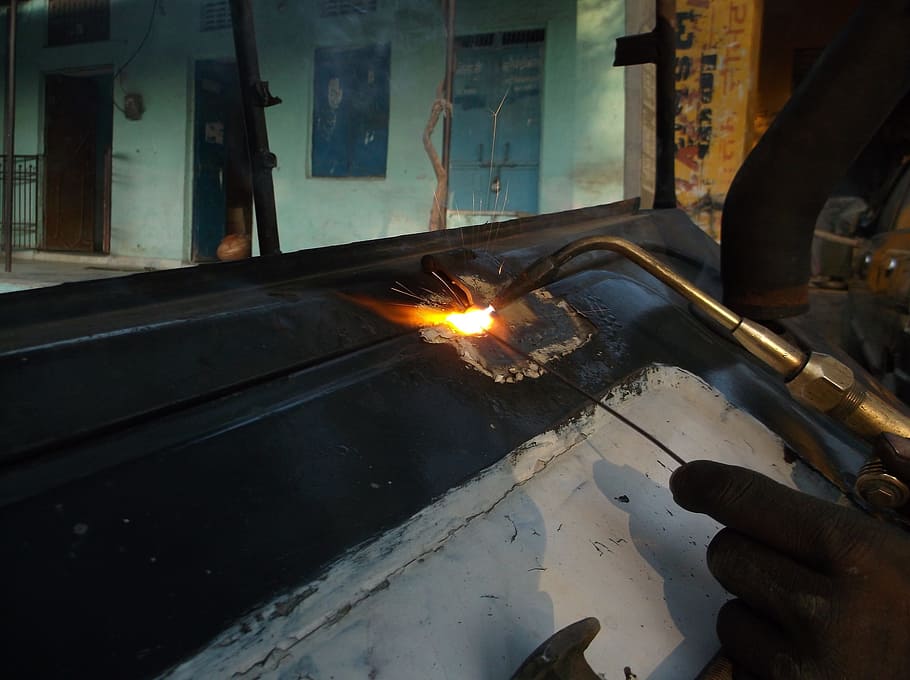 person using welding machine, torch, flame, repair, work, labour HD wallpaper