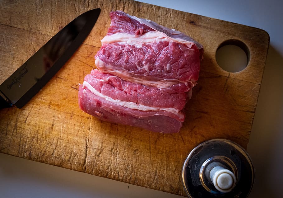 raw meat on brown wooden chopping board besides black kitchen knife, HD wallpaper