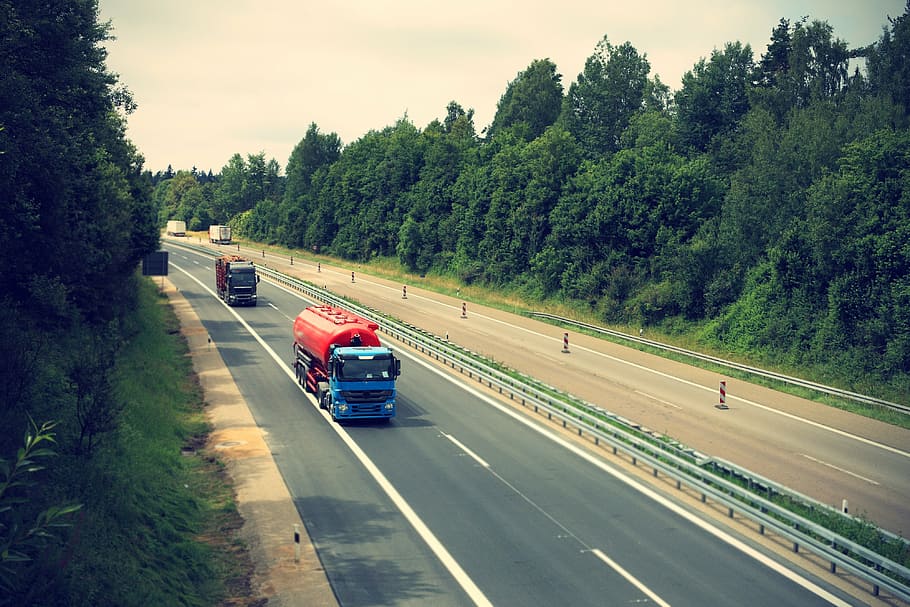blue and red oil truck on road during daytime, highway, logistics