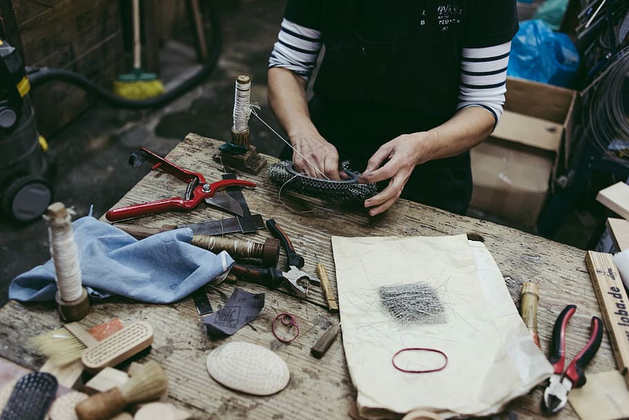 person holding a black bowl, person working, workshop, tools HD wallpaper
