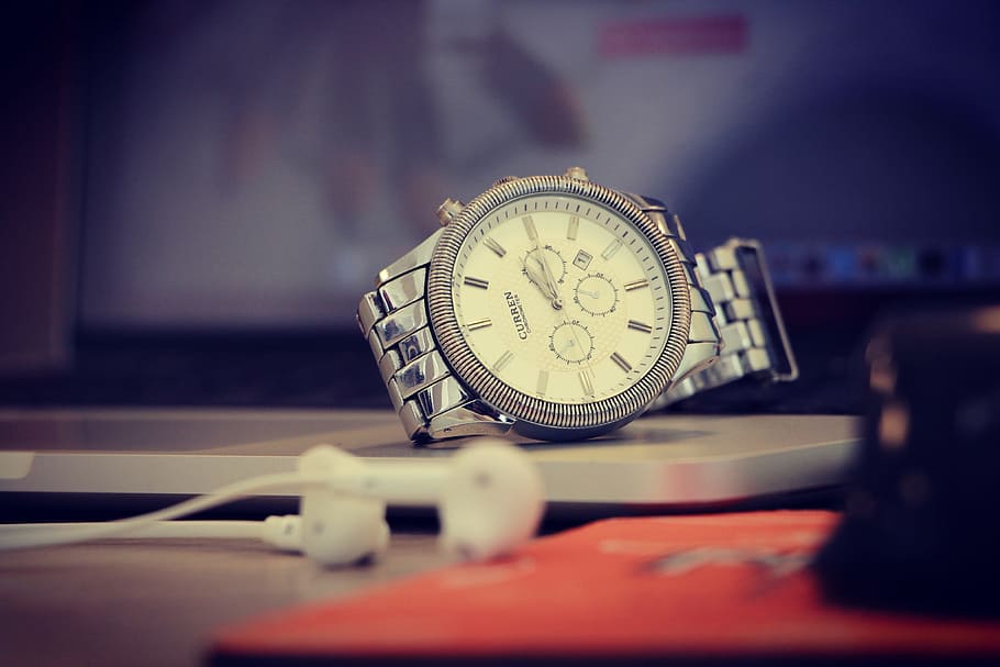 round gold-colored chronograph watch near Apple EarPods, time HD wallpaper