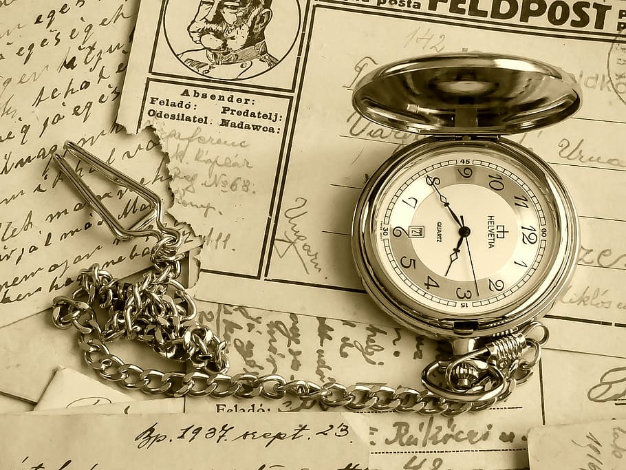 silver-colored pocket watch on white printed papers, hour s, old