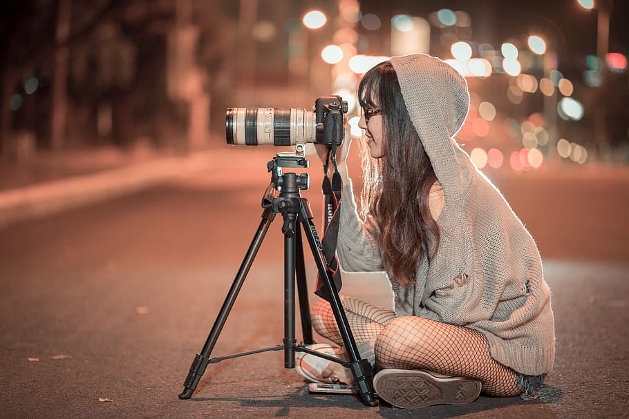 woman in grey hooded jacket sits on road using DSLR camera with tripod, HD wallpaper