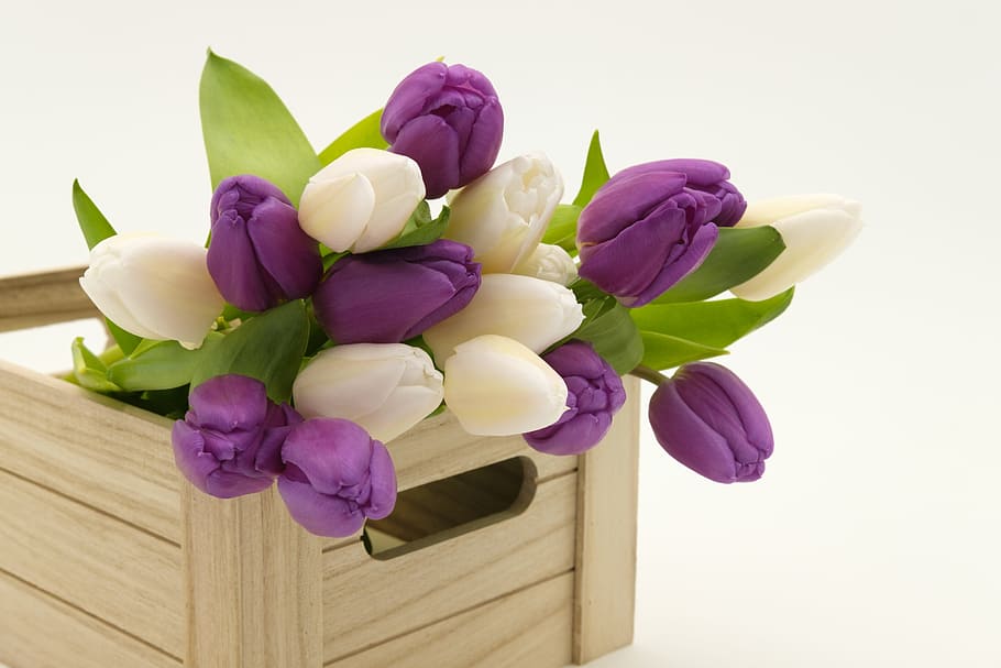 white and purple petaled flowers on brown wooden crate, bouquet