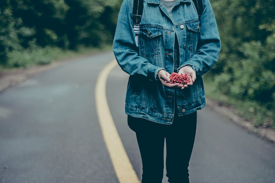 person standing on road holding flower, woman, wearing, blue HD wallpaper