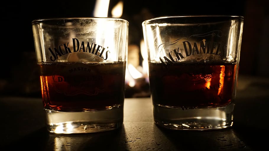 two clear Jack Daniel's shot glasses half-filled with brown liquors, HD wallpaper