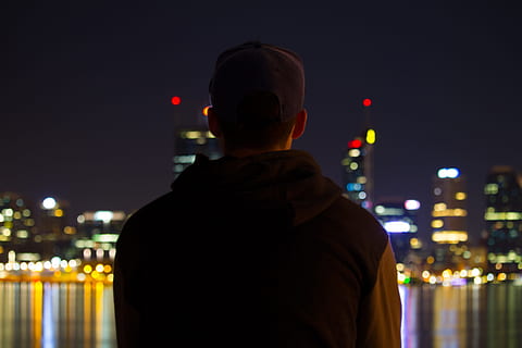 HD wallpaper: Man sitting on a window sill, looking out at night