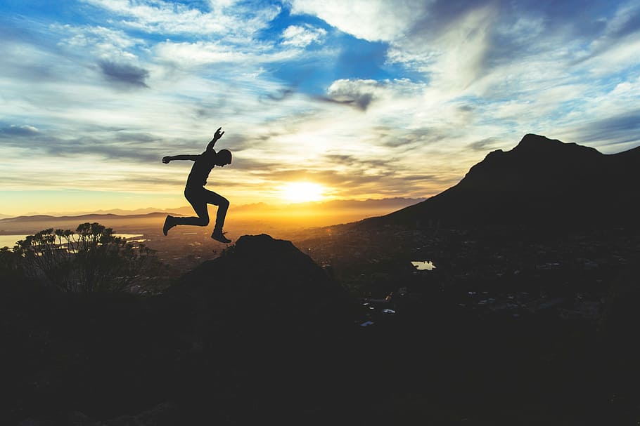 silhouette of a person jumping on mountain, sunset, nature, outdoors HD wallpaper
