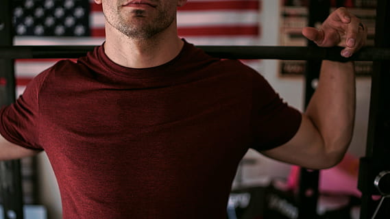 man wearing red crew-neck shirt carrying barbell, man wearing purple crew-neck shirt and holding black handle bar HD wallpaper