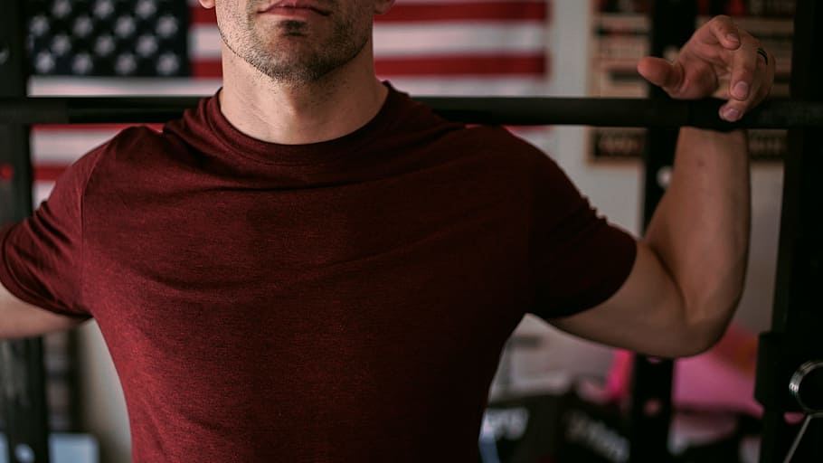 man wearing red crew-neck shirt carrying barbell, man wearing purple crew-neck shirt and holding black handle bar HD wallpaper