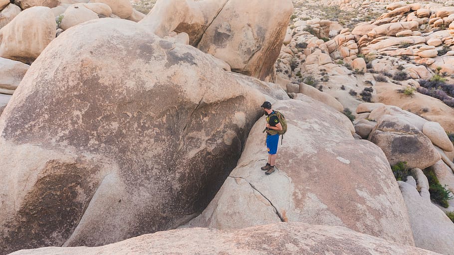 person standing on brown rock, man standing on rock, mountain HD wallpaper