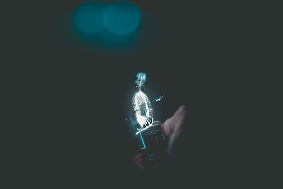 person holding lighted lighter, black LED light, aesthetic, dark