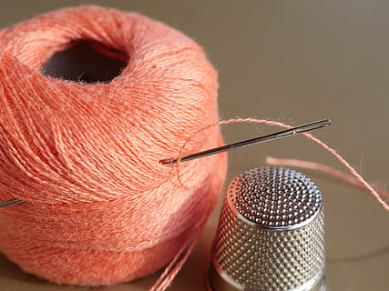 silver thimble beside orange thread with needle, sewing thread HD wallpaper
