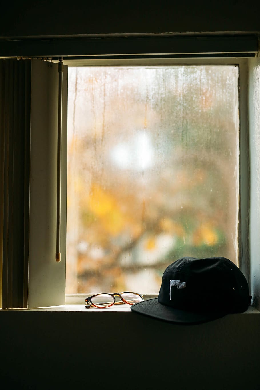 black cap and eyeglasses in front of window, black cap near eyeglasses HD wallpaper