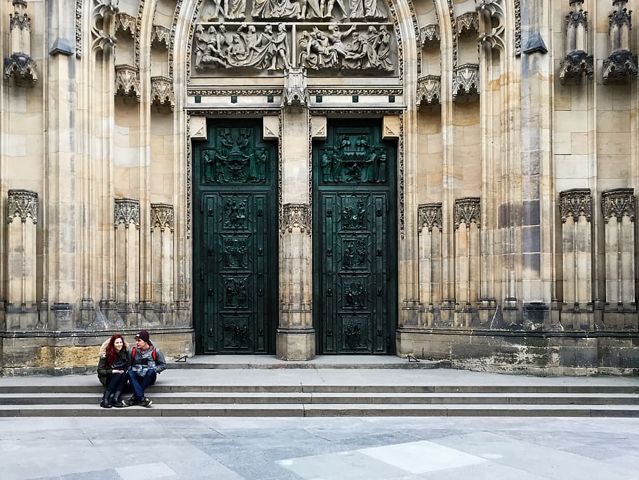 man and woman sitting beside black gate, architecture, building HD wallpaper