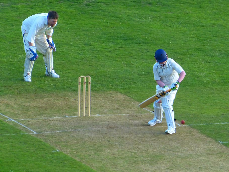 Full length of batsman playing cricket on pitch against blue sky from  Pikwizard