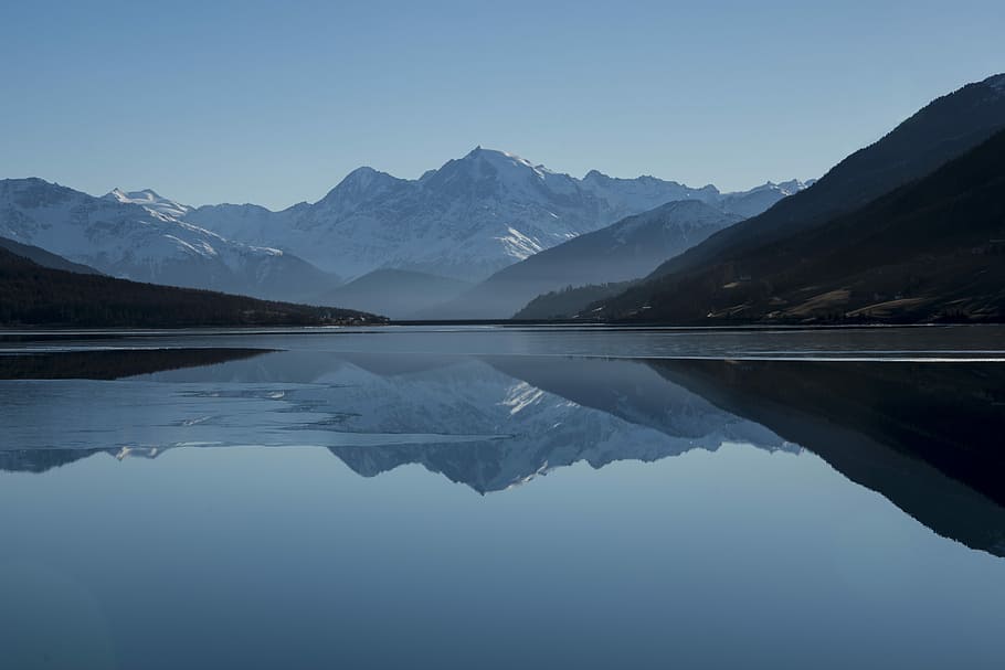 mountain near on body of water photo, grey calm body of water near snow covered mountains at daytime HD wallpaper