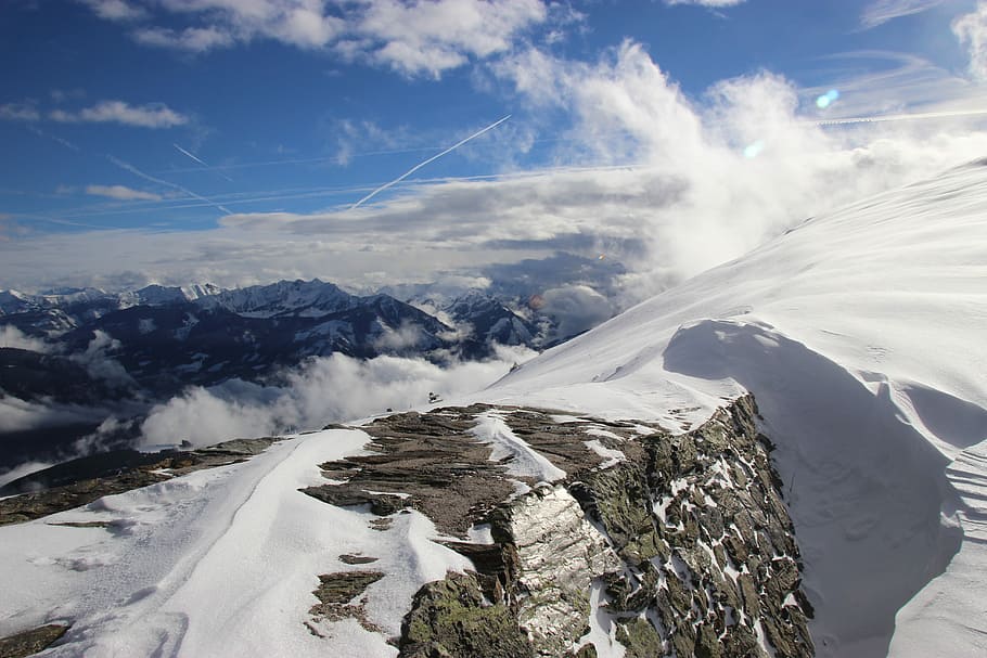 snow mountain during daytime, aerial photography of snow covered mountain overlooking hills under white and blue cloudy skies at daytime HD wallpaper