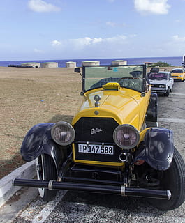 vintage yellow car parked near body of water, cuba, oldtimer HD wallpaper