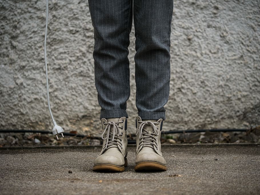 person wearing gray boots, person wearing gray boots standing near white wall HD wallpaper