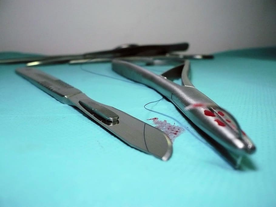 close up photography of medical knife and forceps, surgery, tools