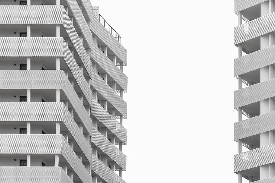 white concrete buildings under white sky, grey high-rise building HD wallpaper
