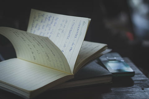 black candybar phone beside book on table, blur, cellphone HD wallpaper