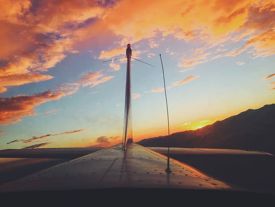 gray and black metal plane blade board, white windmill under orange and blue sky during sunset HD wallpaper