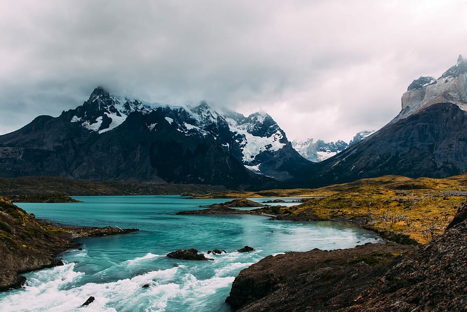 body of water surrounded by mountains, body of water near mountain HD wallpaper