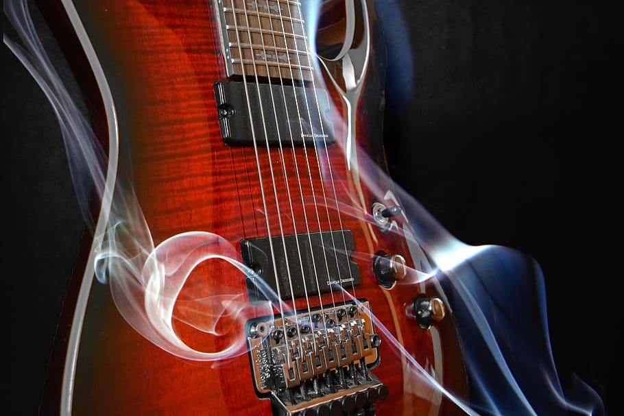 closeup photo of brown electric guitar with smoke wallpaper, eight strings