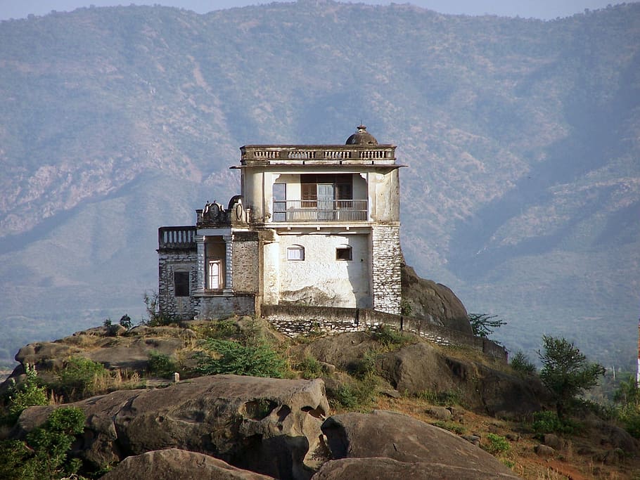 white and gray concrete house on hilltop during daytime, Mount Abu