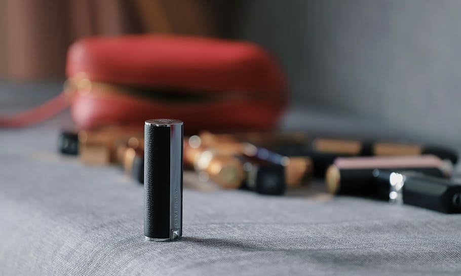 gray tube on sofa, lipstick lot with case, makeup, bag, indoors HD wallpaper
