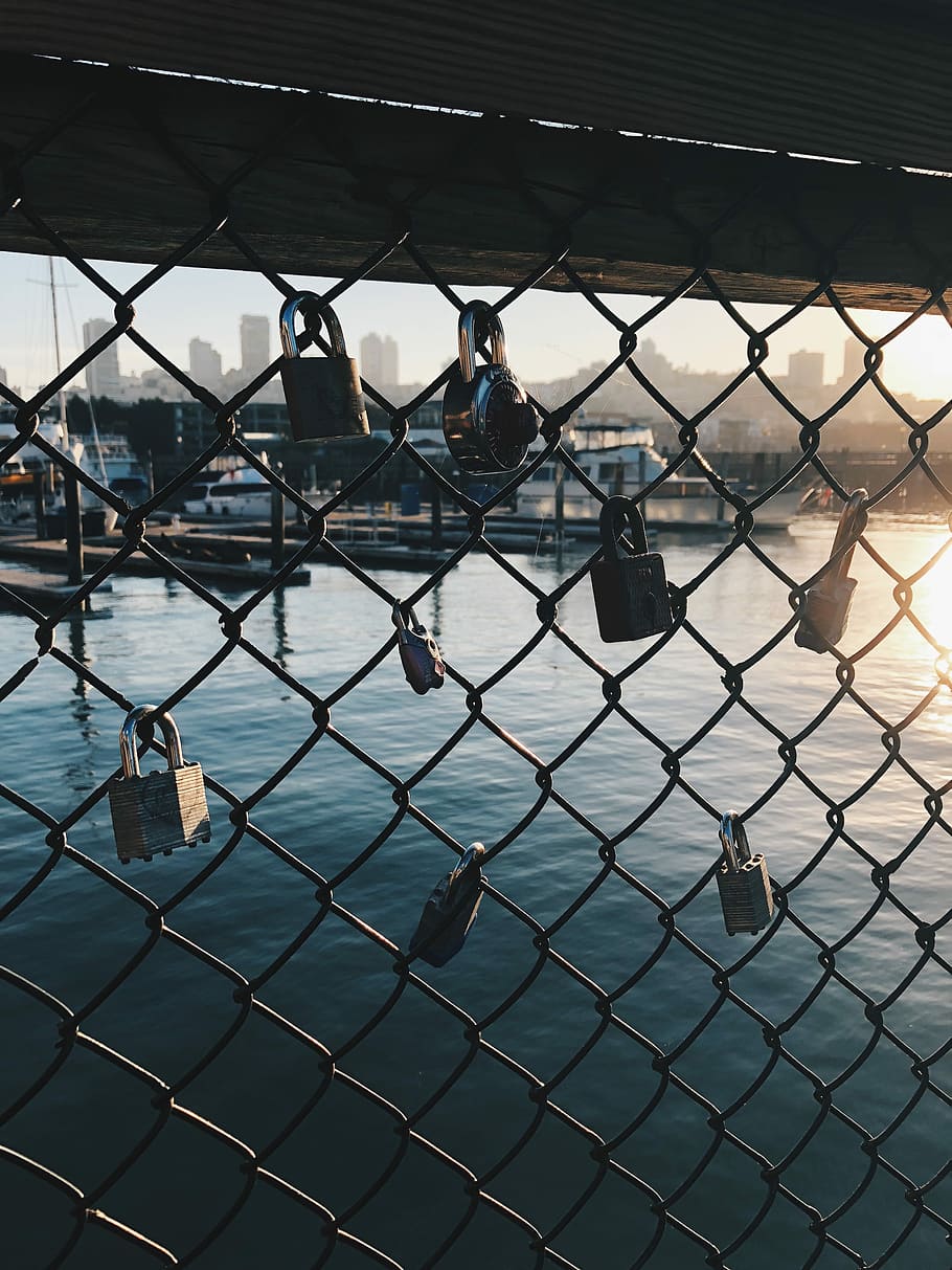 gray chain link with padlock over body of water, stainless steel padlocks on cyclone fence HD wallpaper