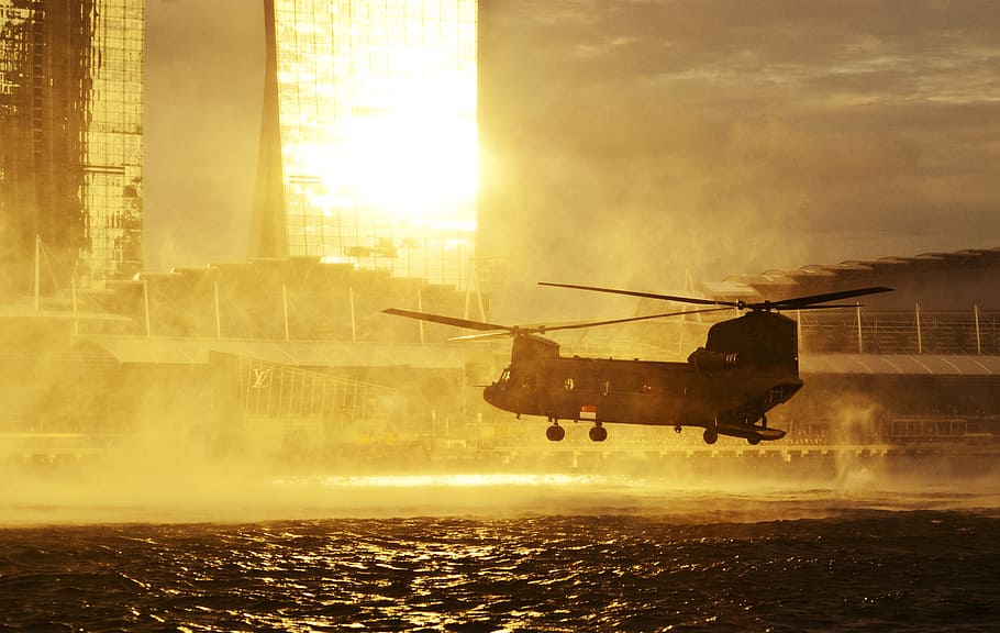 gray carrier helicopter over the sea near city, hovering, water HD wallpaper