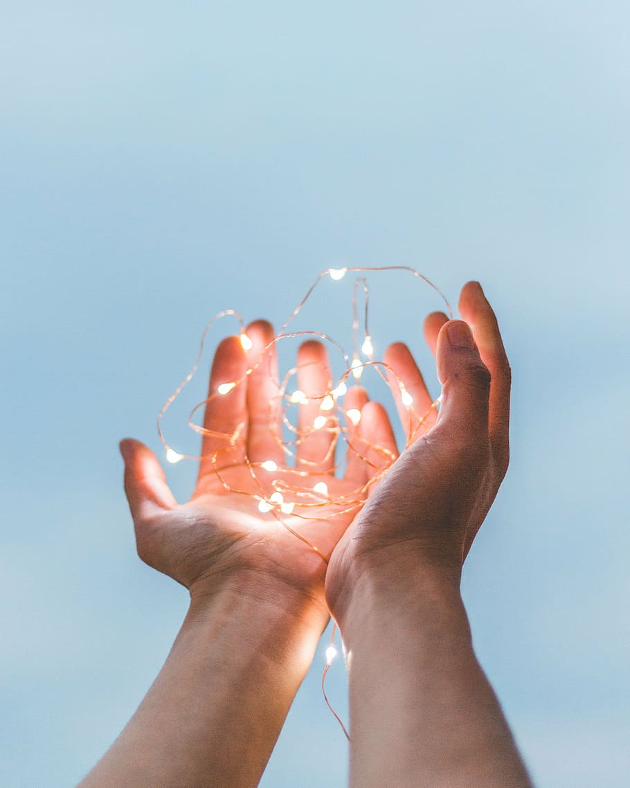 person holding string lights during daytime, hands, palm, electricity HD wallpaper