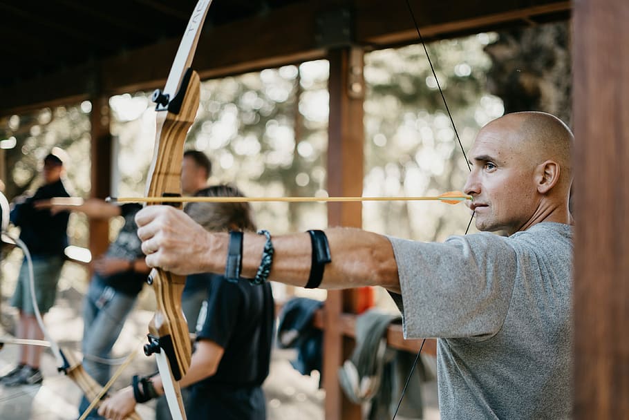 man using a brown bow, man in gray shirt bending bow, male, arrow, HD wallpaper